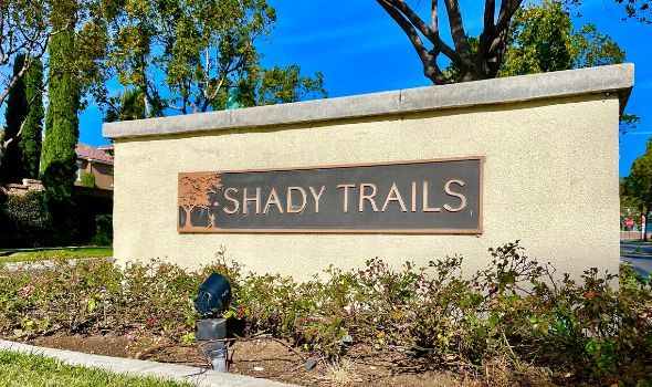 Shady Trails cemented signage with pale yellow paint | Homes For Sale in Shady Trails Fontana | Alvin Tapia