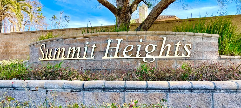 Beautiful landscape with metal Summit Heights signage attached to brick planter-Summit Heights Fontana Homes For Sale-Featured Image-Alvin Tapia