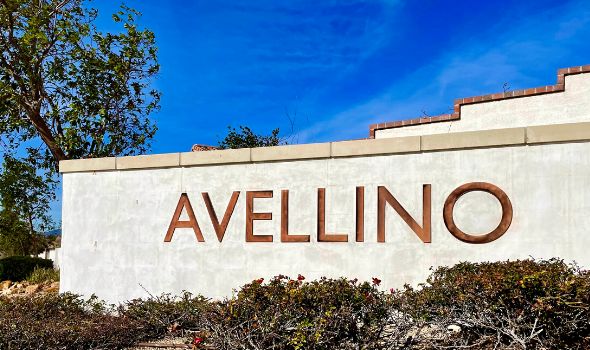 White wall with the word Avellino in brick red font color | Fontana Homes For Sale | Alvin Tapia